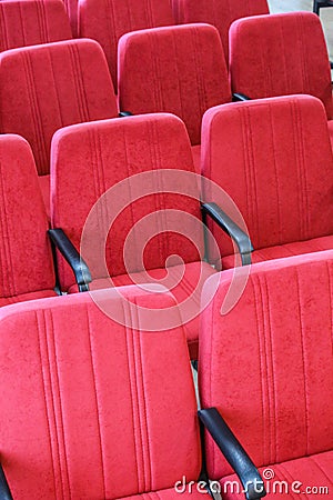 Red chair close-up. Rows seats in empty movie theater. Stock Photo