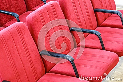 Red chair close-up. Rows seats in empty movie theater. Stock Photo
