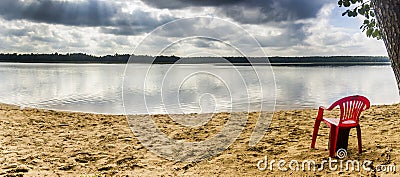 Red chear on lake beach Stock Photo