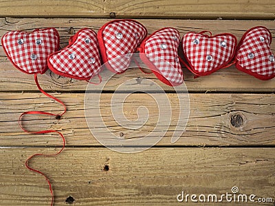 Red check hearts on rustic wooden background Stock Photo