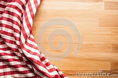 Red checkered fabric on wood table background.For decoration key visual Stock Photo