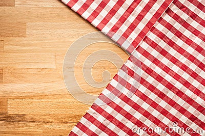 Red checkered fabric on wood table background.For decoration Stock Photo