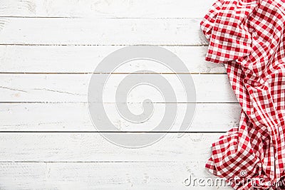 Red checkered kitchen tablecloth on wooden table Stock Photo