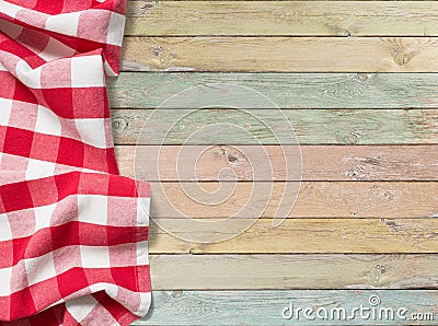 Red checkered picnic tablecloth on colorful wood table Stock Photo