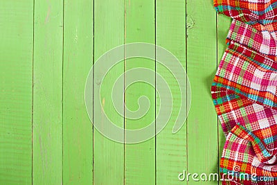 Red checkered tablecloth on a green wooden table with copy space for your text. Top view Stock Photo