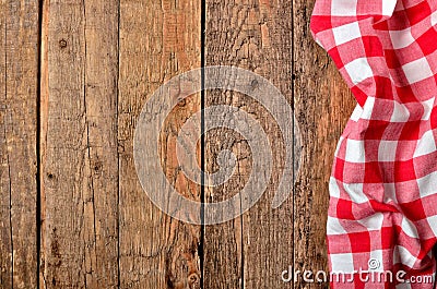 Red checkered tablecloth right frame on vintage wooden table background - view from above Stock Photo