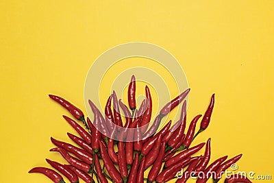 Red chili pepper on fire shape on yellow background, top view Stock Photo