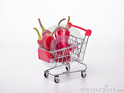 red chili peppers in a food basket on wheels. red peppers on a white Stock Photo