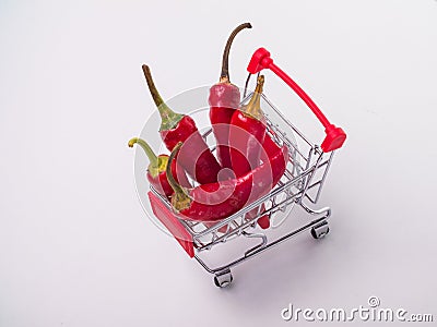 red chili peppers in a food basket on wheels. red peppers on a white Stock Photo