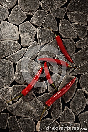 Red chili peppers on a grey stone background Stock Photo
