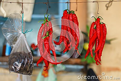 Red Chili Peppers hanging outdoor in the market Stock Photo
