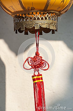 Red Chinese knot decoration attached to a traditional lantern Stock Photo