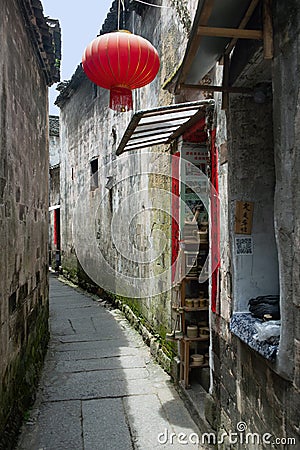 A red Chinese lantern hangs outside a small alley shop in Hongcun, China Editorial Stock Photo