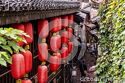 Fenghuang,China- 10/19/2018 Red Chinese lanterns are being hang from the roof of the old Chinese styled building Editorial Stock Photo