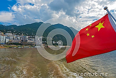 Red Chinese national flag fluttering on a sightseeing ship on Yangtze River Editorial Stock Photo