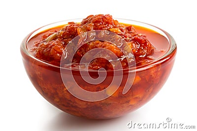 Red chopped chilli peppers in oil in glass bowl. Stock Photo