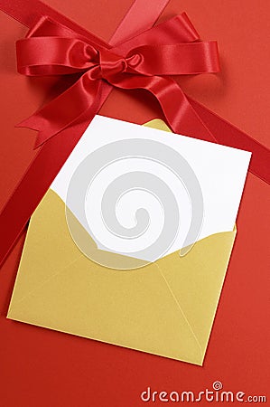 Red christmas gift background with gold envelope and blank invitation or card, vertical Stock Photo