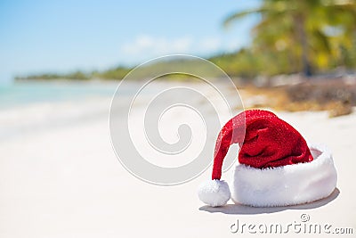 Red Christmas hat on the beach Stock Photo