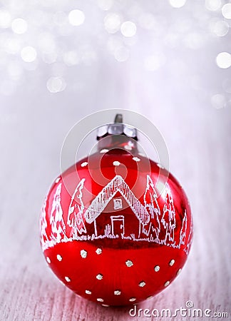 Red Christmas ornament on glitter silver background with space for text. Merry Christmas and New Year card Stock Photo