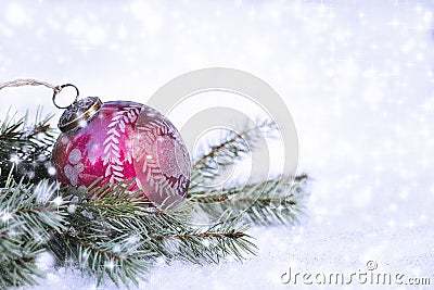 Red Christmas Ornament on Pine Branches and Snow Stock Photo