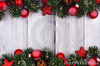 Red Christmas ornaments and branches double border on white wood Stock Photo