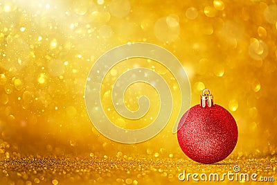 Red Christmas ornaments on golden holiday background with twinkle bokeh light. Stock Photo