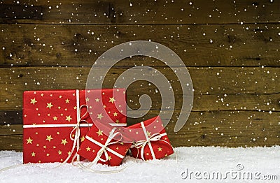 Red christmas presents on wooden background with snowflakes. Stock Photo