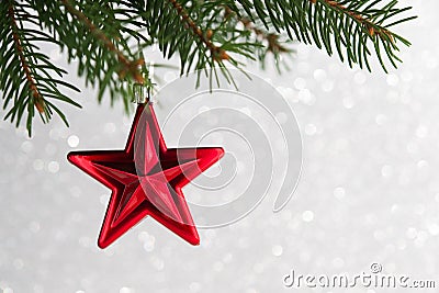 Red christmas stars on the xmas tree on glitter bokeh background. Stock Photo