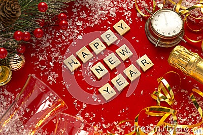 Red Christmas theme background with lettered wooden tiles forming the words Happy New Year Stock Photo