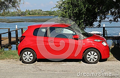 Red Citroen C1 parked by the sea. Side view. Editorial Stock Photo