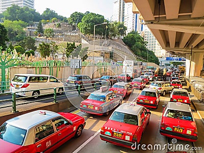 Red city taxis in road traffic, Hong Kong Editorial Stock Photo