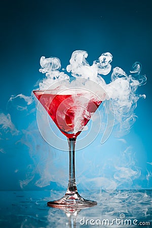 Red cocktail with ice vapor Stock Photo