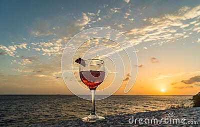 Red cocktail overlooking the sea- Drinks at Sunset Curacao Views Stock Photo