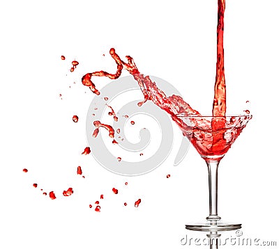 Red cocktail splashing from glass Stock Photo