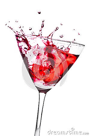 Red cocktail with splashing in the tilted glass Stock Photo