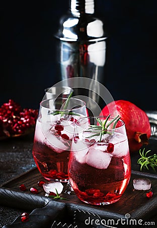 Red cocktail vodka pomegranate juice, with ice and rosemary, bar tools, blue bar counter background, top view Stock Photo