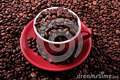 Red coffee cup filled with roasted beans closeup top view Stock Photo