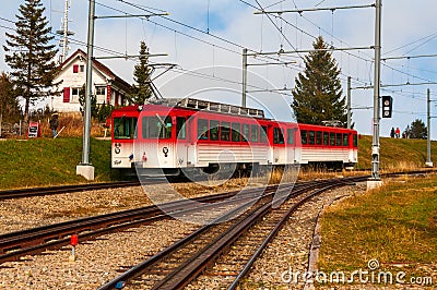 Red cogwheel train on Rigi Mountain, Swiss Alps Editorial Stock Photo