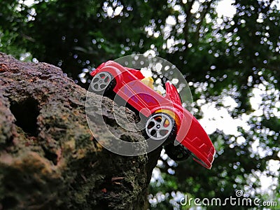 Red color car toy in stone picture Stock Photo