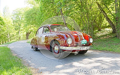 Red color Tatra T600 Tatraplan classic car from 1951 driving on a country road Editorial Stock Photo