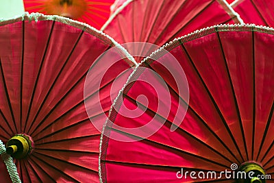 Red color umbrellas close up, traditional craftsmanship in Chiangmai, Thailand Stock Photo