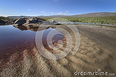 Red coloration in pool beside river due to iron, Sarek, Sweden Stock Photo