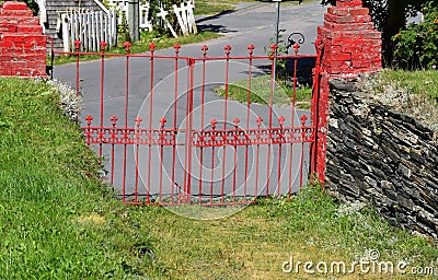 Red colored churchyard gate Stock Photo
