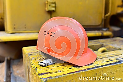 Red construction helmet. Headwear to protect the head of the worker when performing hazardous building work. Safety concept at the Stock Photo