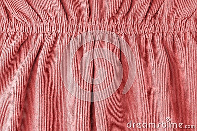 Red velveteen fabric with folds on elastic. Cloth background, velveteen texture. Stock Photo