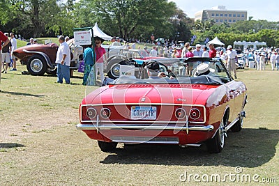 Red Corvair convertible driving on lawm Editorial Stock Photo