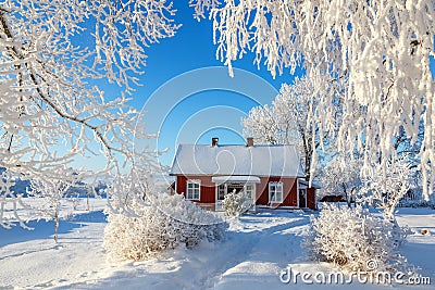 Red cottage in a beautiful cold winter landscape Stock Photo