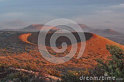 Red craters of Mauna Kea at sunset Stock Photo