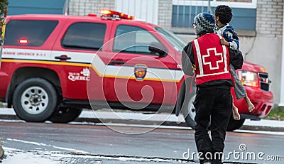 Red cross volunteer help kid after firehouse Editorial Stock Photo