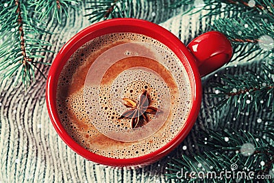 Red cup of hot cocoa or hot chocolate on knitted background with fir tree, traditional beverage for winter time Stock Photo